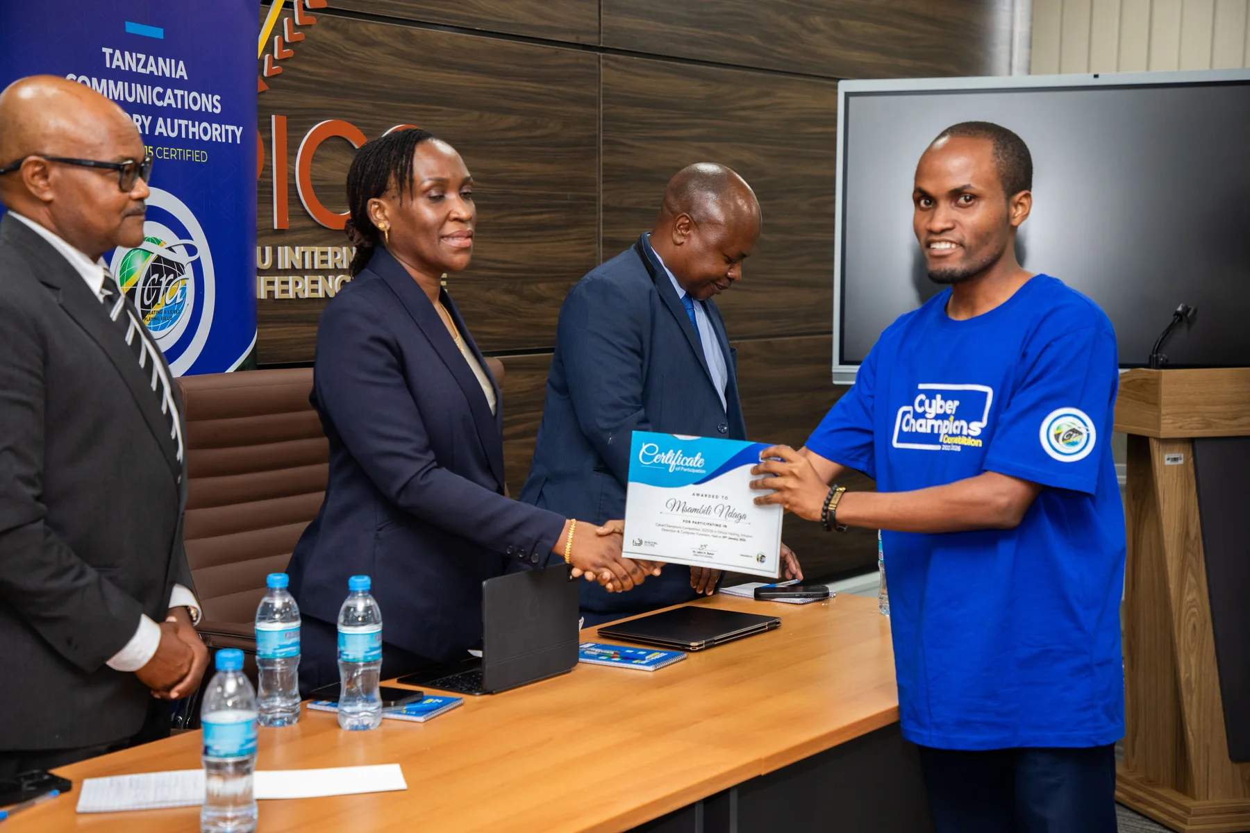 Msambili Ndaga receiving a Cyberchampions certificate at TCRA